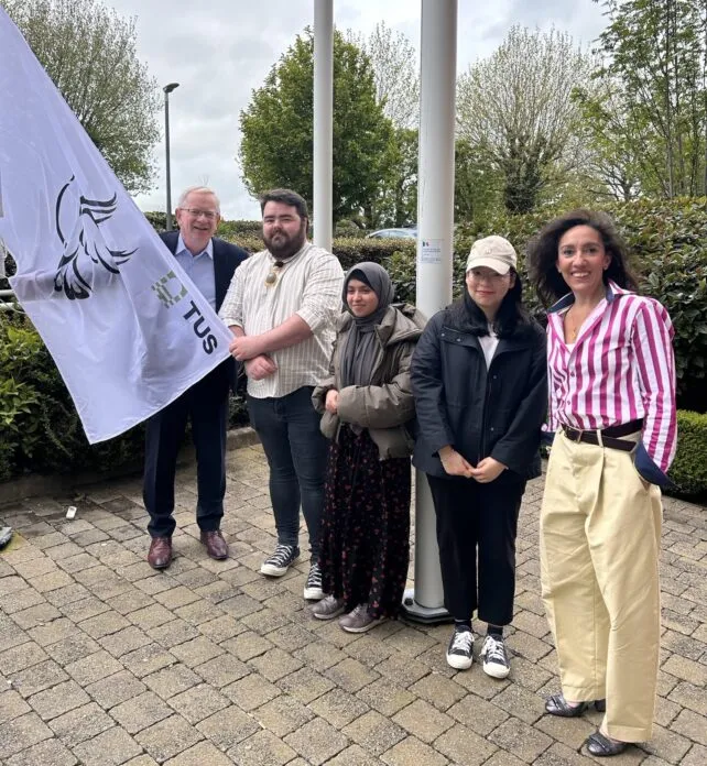 TUS President Prof. Vincent Cunnane raises the peace flag at TUS Moylish Campus..